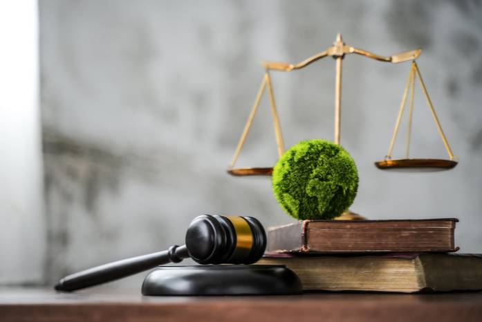 gavel with green planet and scale to represent environmental equity and justice