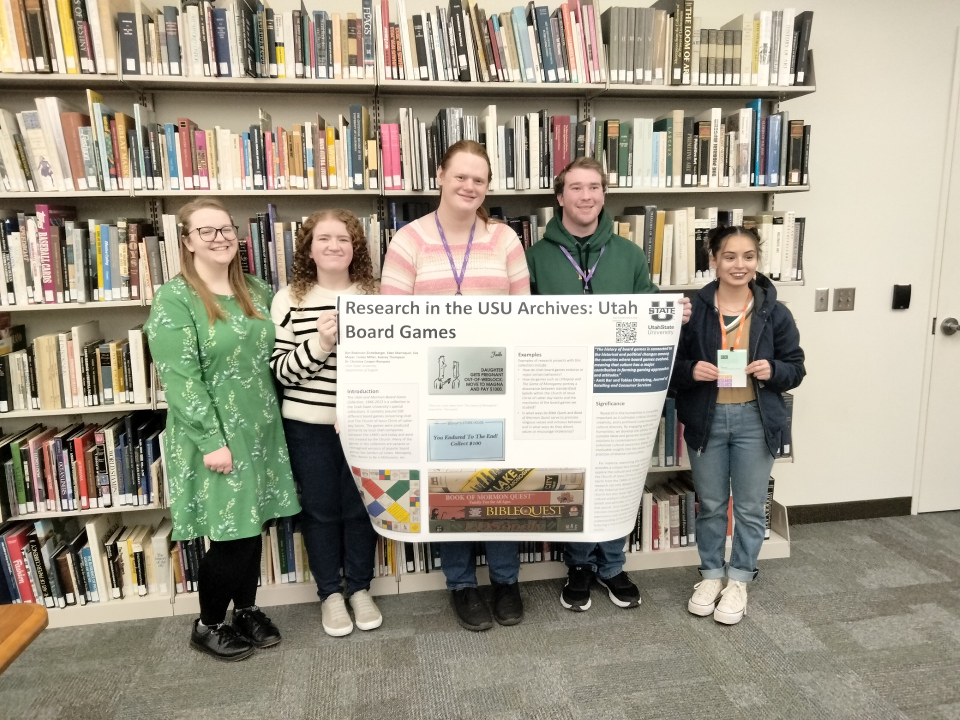 English students hold a poster presentation of Utah board games