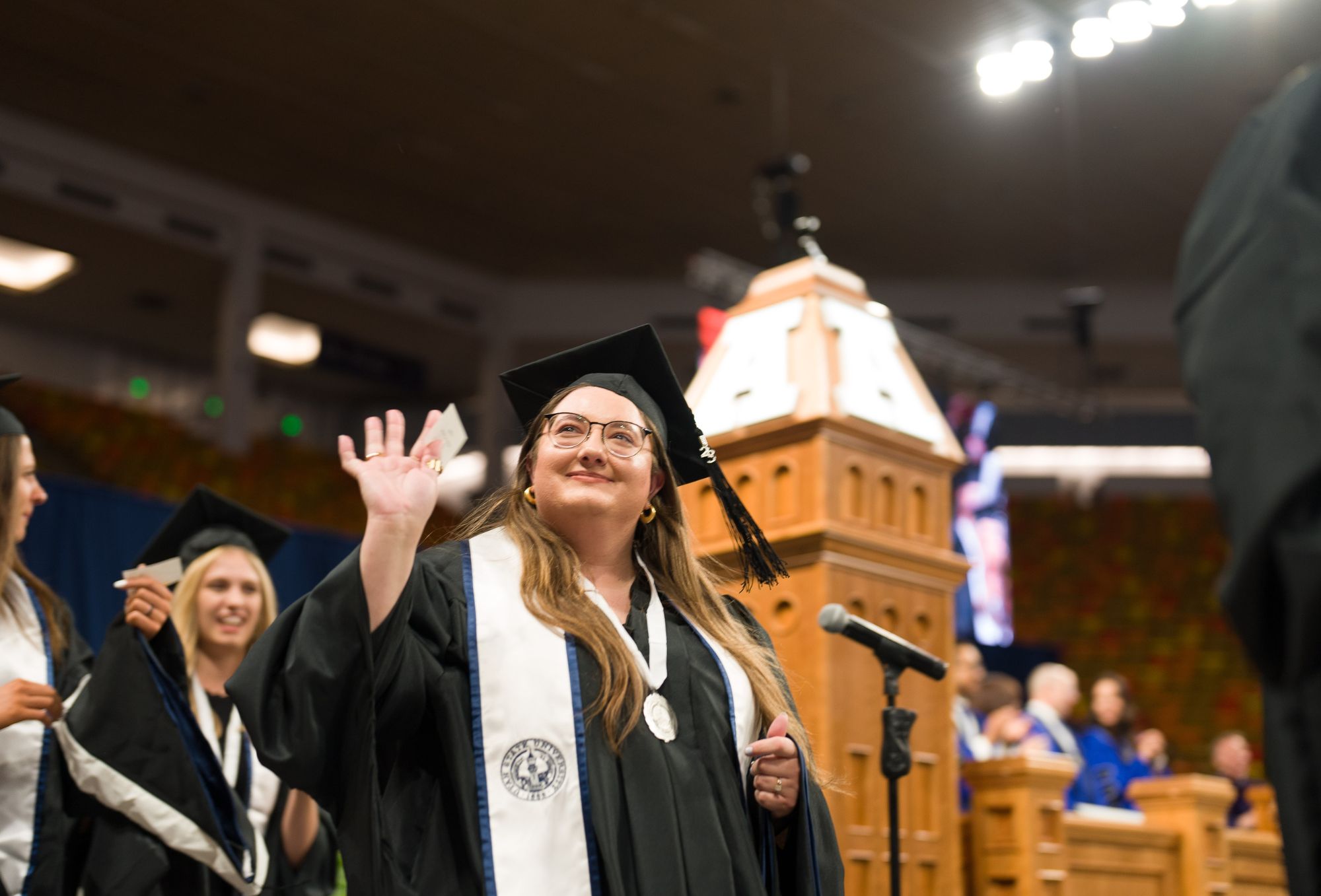 graduation photo depicting students graduating in their cap and gowns from USU.