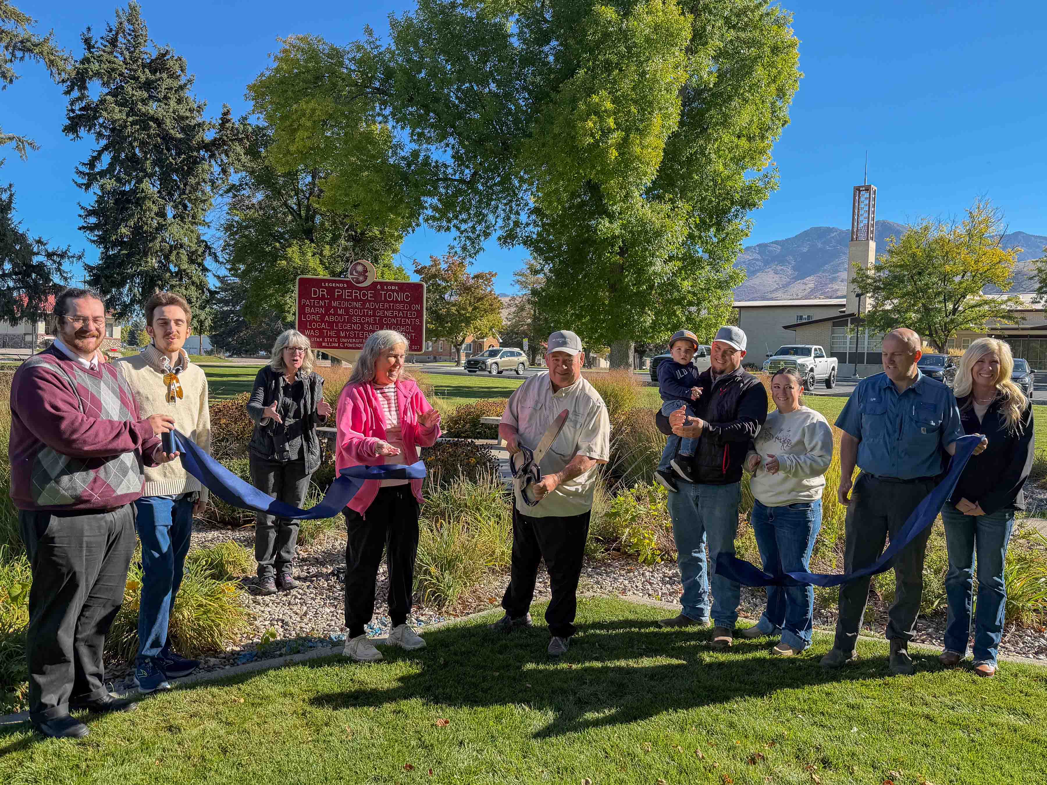 Ribbon Cutting, Dr. Pierce Barn Pomeroy Sign, Richmond City Park, 176 W 100 S, Richmond, UT. L-R: Jason Matthews, Kade Martinez, Jeannie Thomas, Terry Spackman, Brady Spackman family, Lyle Bair (Richmond City Council), and HollyJo Karren (Richmond City Administrator).