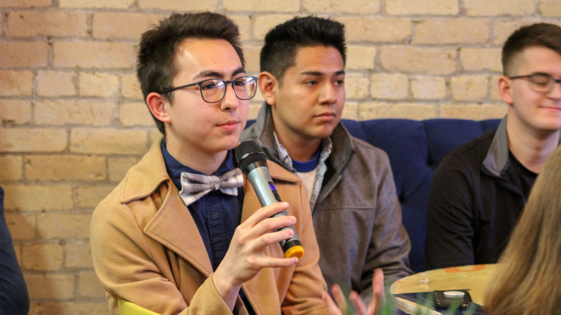 A man holds a microphone to his mouth