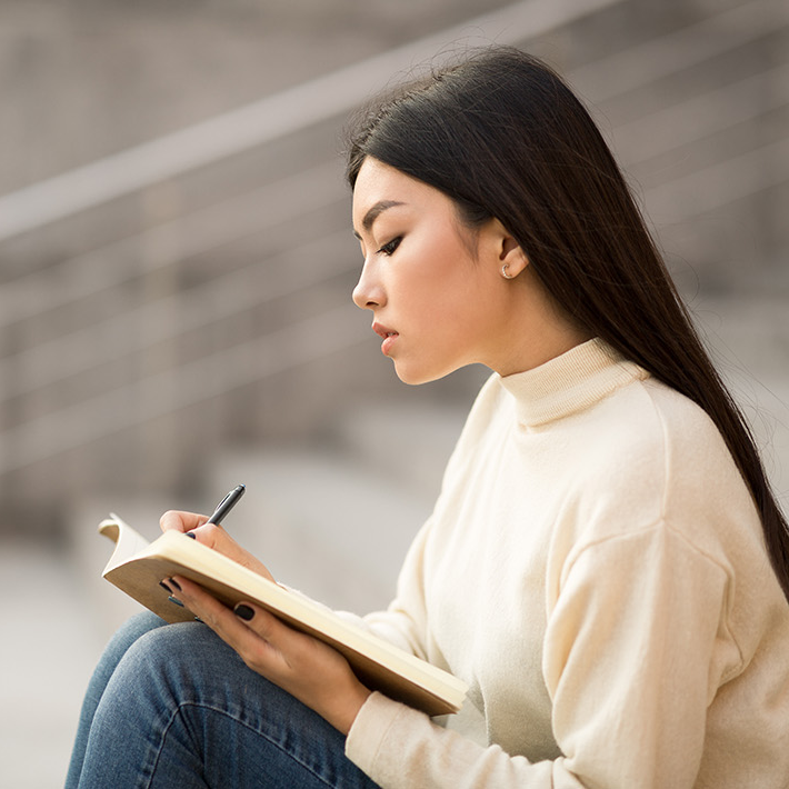 Person writing in journal