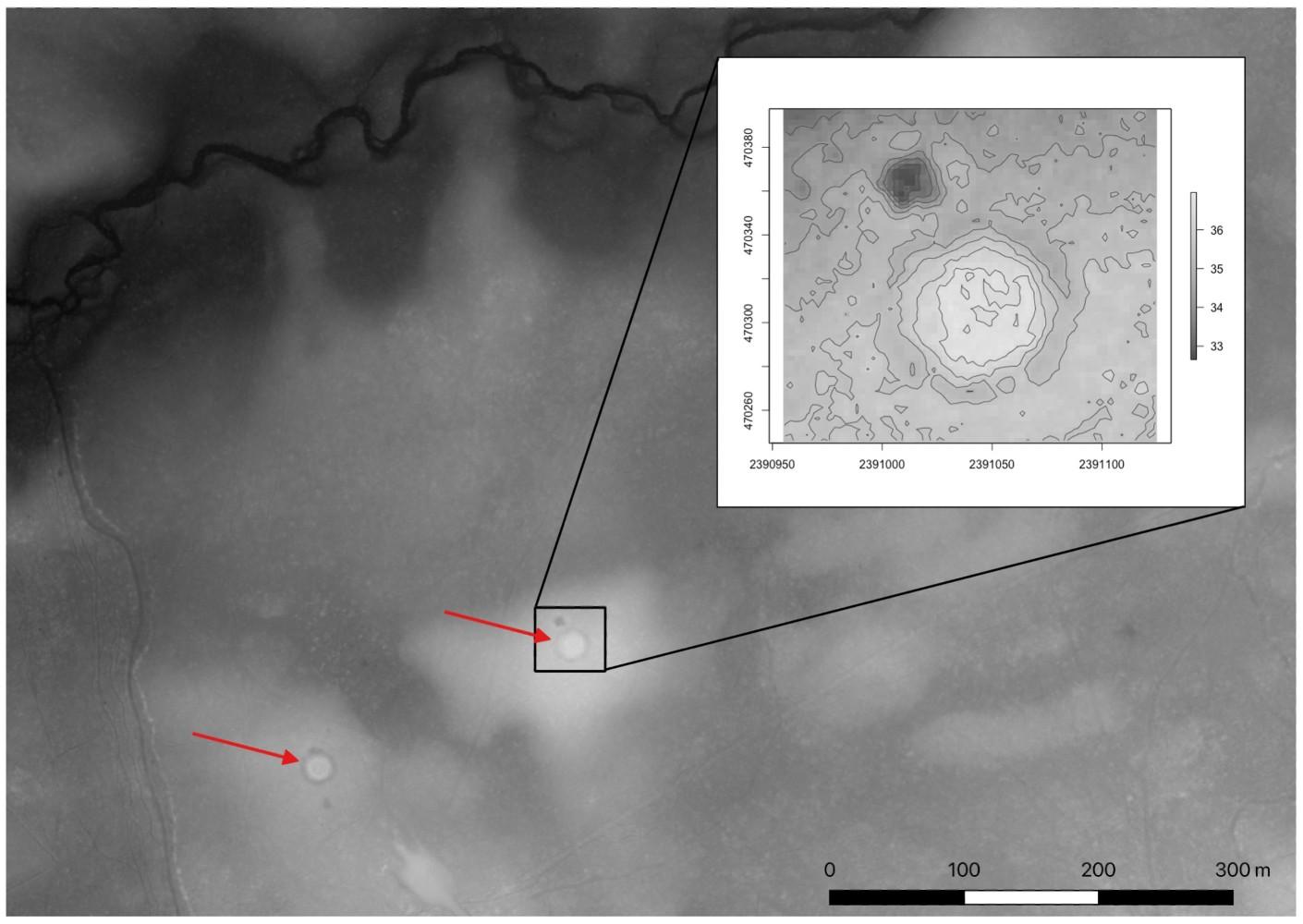 A black and white scan indicating two spots of interest on a map with red arrows. A portion of the image shows an expanded view of one of the spots.
