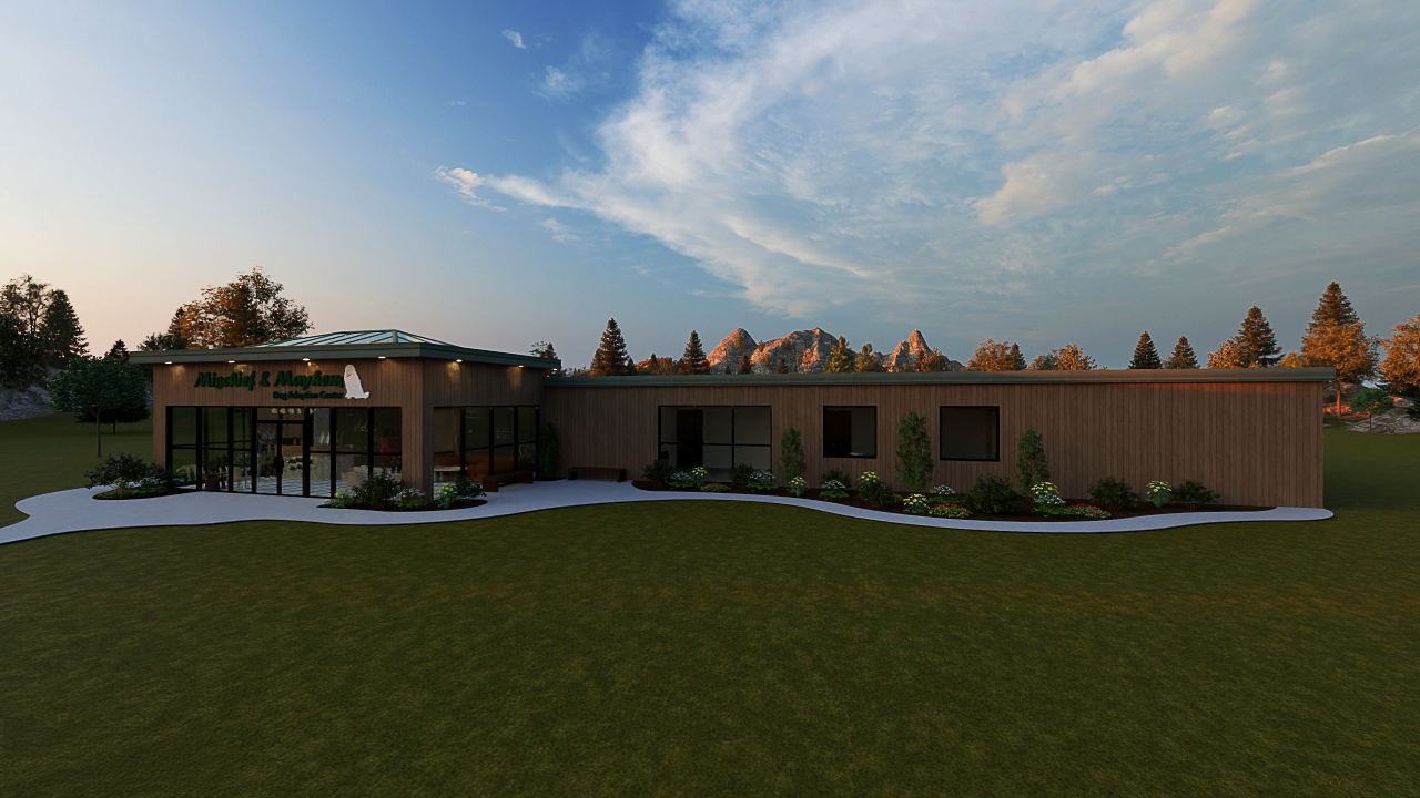Exterior rendering of the Mischief & Mayhem Dog Adoption Center, showcasing its modern wood-clad facade, green metal roof, and large glass windows set against a scenic mountain backdrop at sunset.
