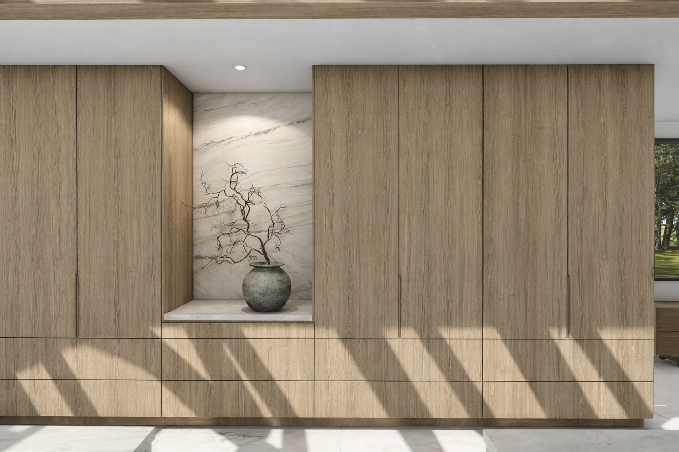  light oak, floor to ceiling cabinetry along a kitchen wall.