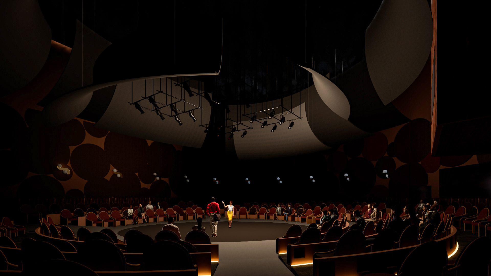 A a theater in the round set up with seats on risers surrounding a central stage.