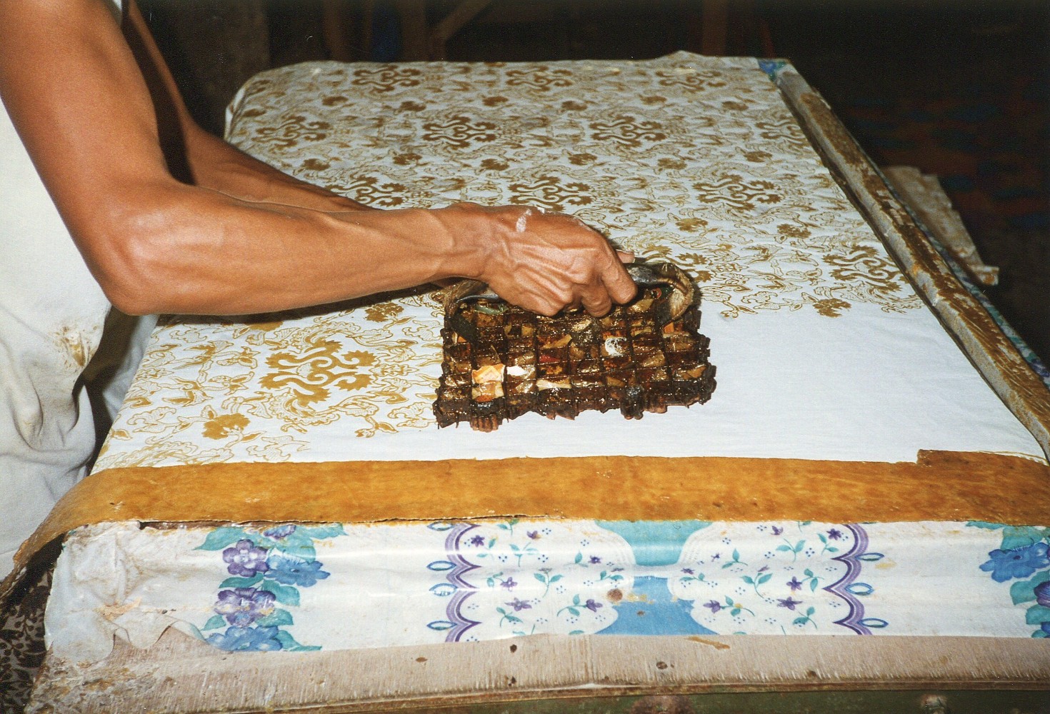 A pattern being stamped onto a fabric.