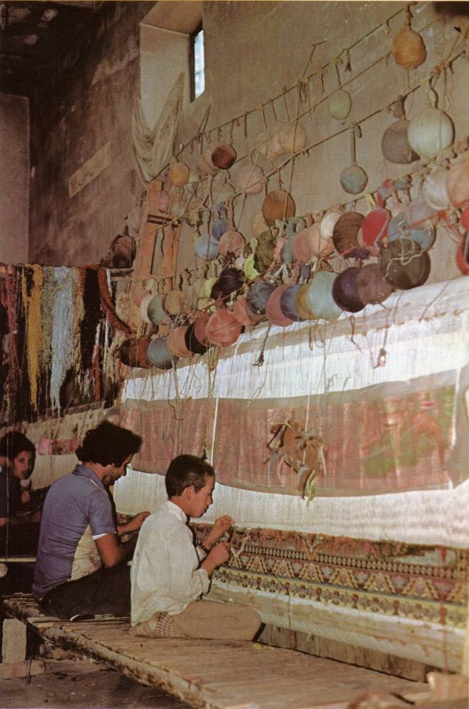 A tapestry in the process of being made.