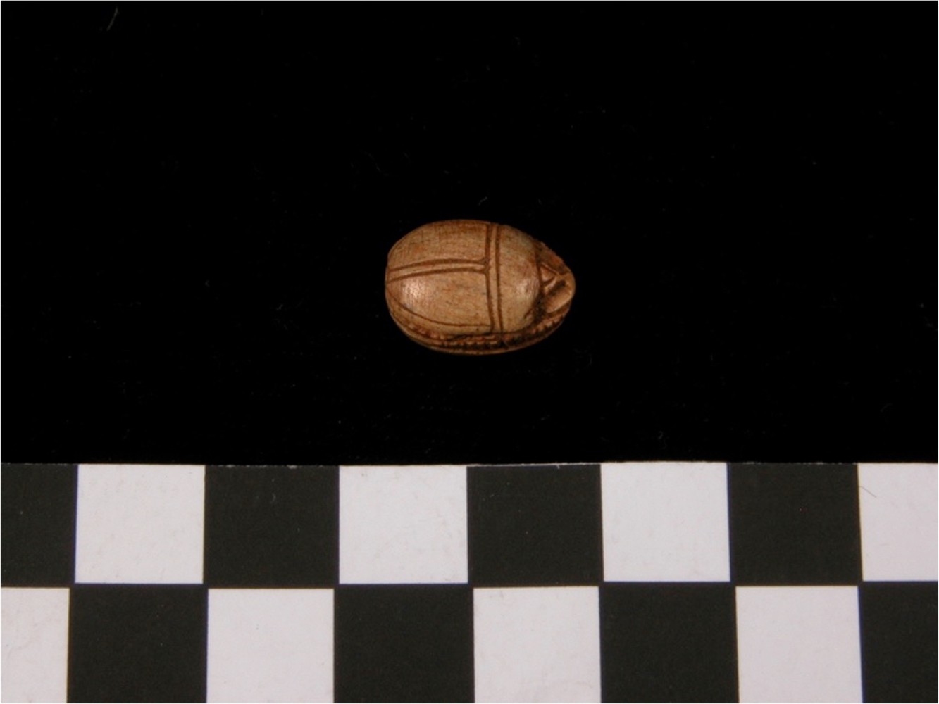 A small, carved wood artifact.