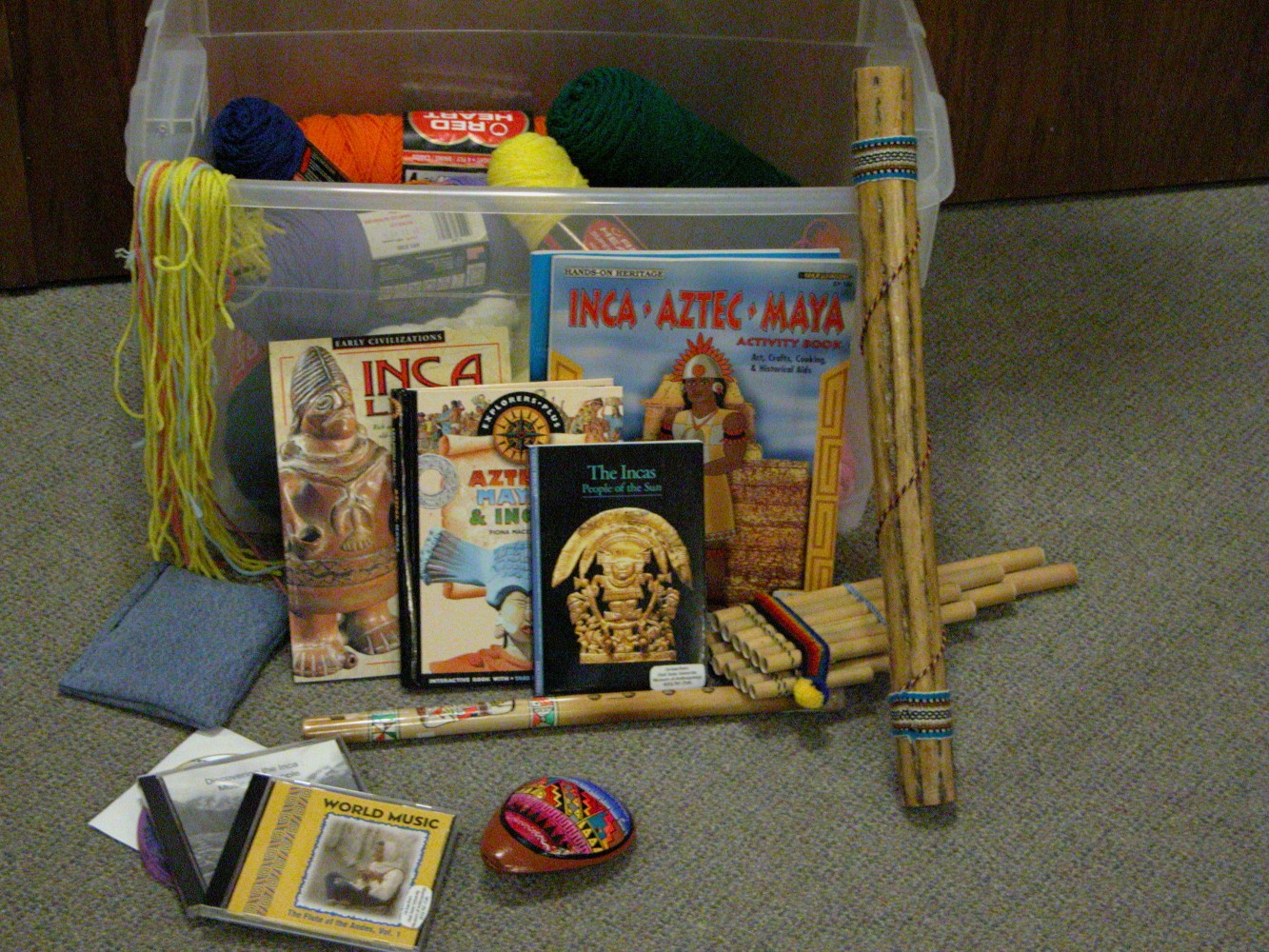 A bin full of Native American books, artifacts, and activity supplies.