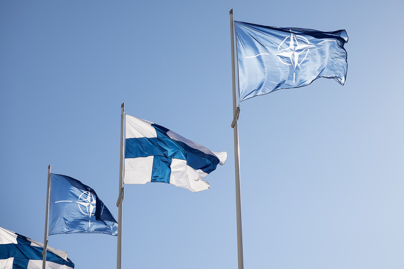 Finnish and NATO flags fly during Finland’s acceptance ceremony.