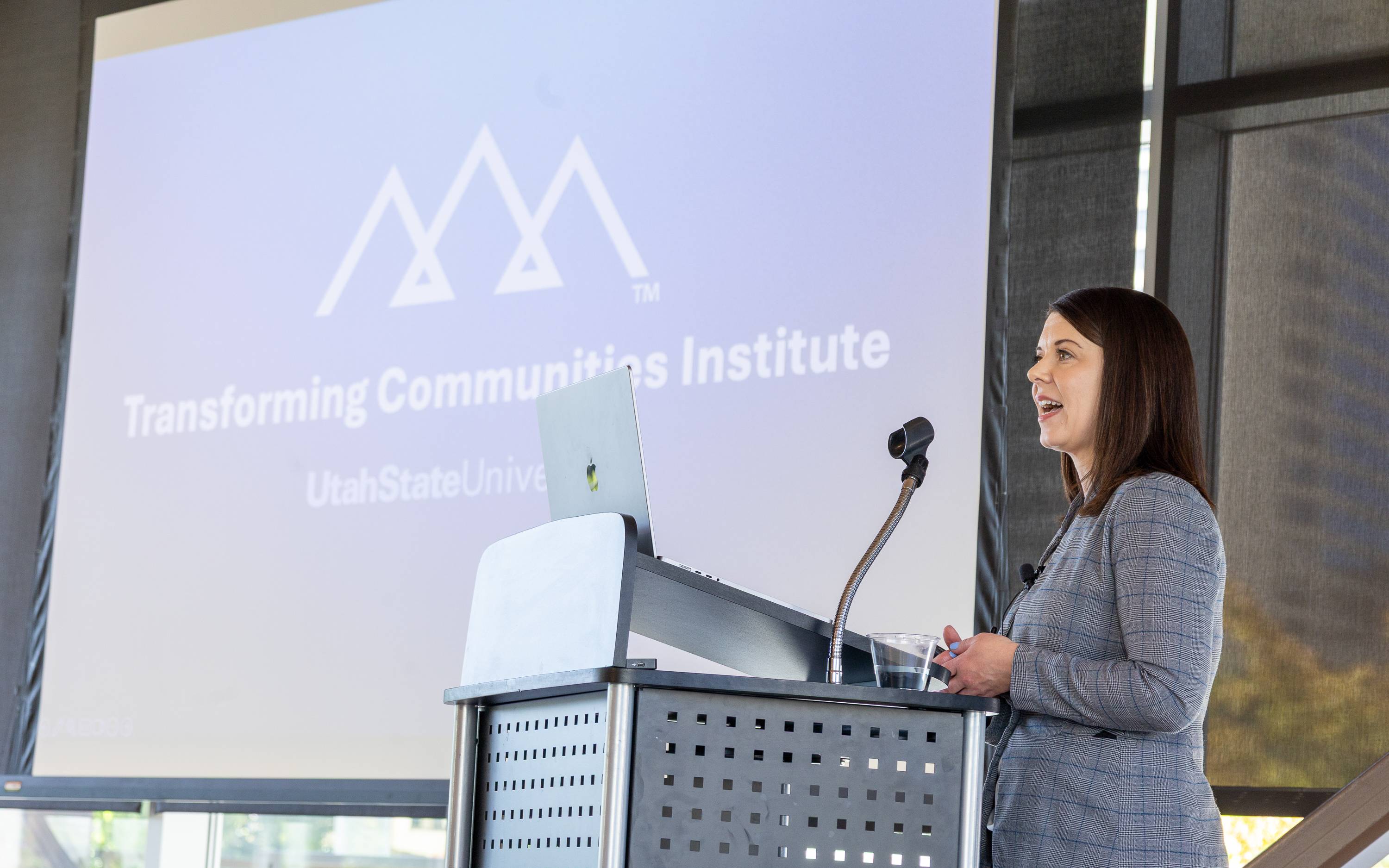 Presenter speaking at Transforming Communities Institute event